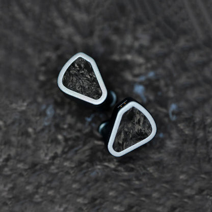 Top view of SYMPHONIUM Audio- Giant IEM (Launch Edition) on a textured surface, showcasing its artistic faceplate and robust design.