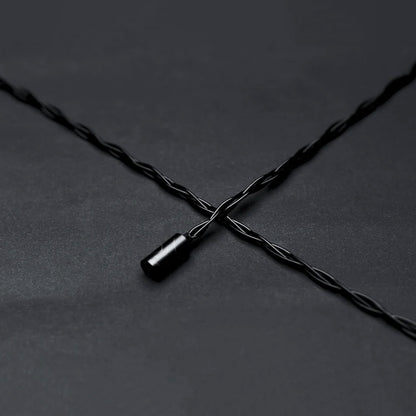 High-quality twisted black audio cable compatible with SYMPHONIUM Audio- Giant IEM (Launch Edition) for optimal signal transmission.