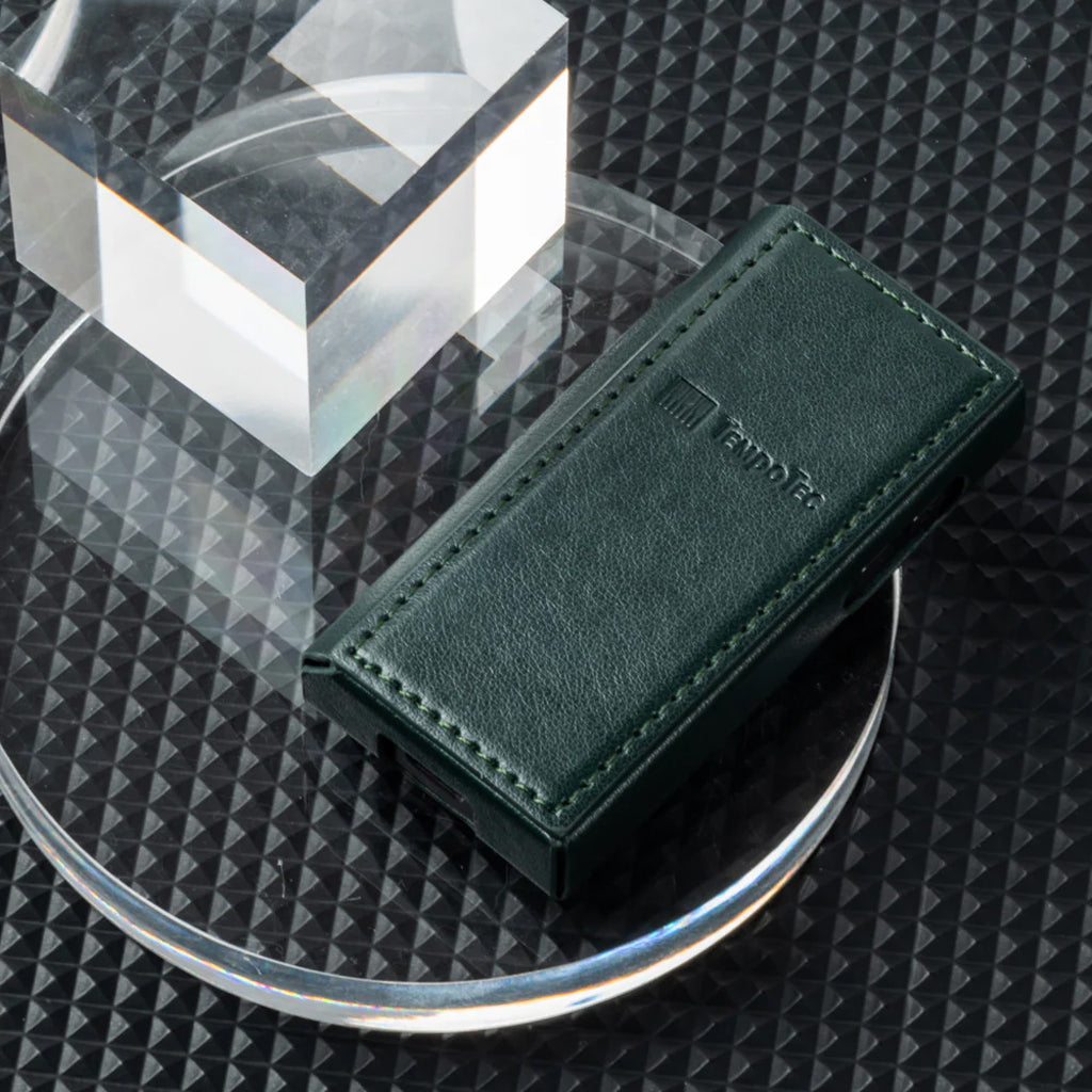 TempoTec V1 Series PU leather case placed on a textured surface, emphasizing premium design and protective build for handheld electronics.