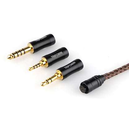 Close-up of Tripowin Amber's modular 3-in-1 gold-plated plugs for 2.5mm, 3.5mm, and 4.4mm outputs, enhancing IEM compatibility.