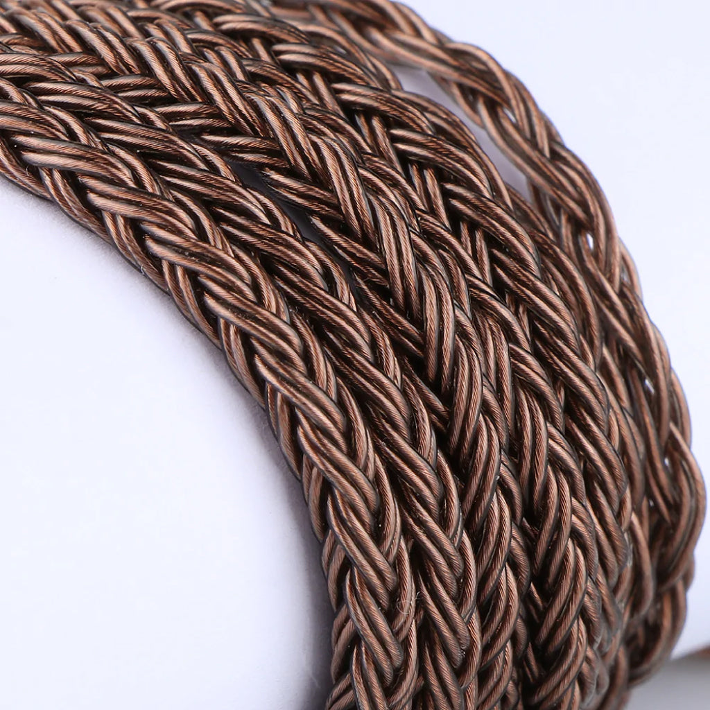 Macro shot of Tripowin Amber's braided copper cable, showcasing its premium 14-core OFC construction for optimal audio clarity.