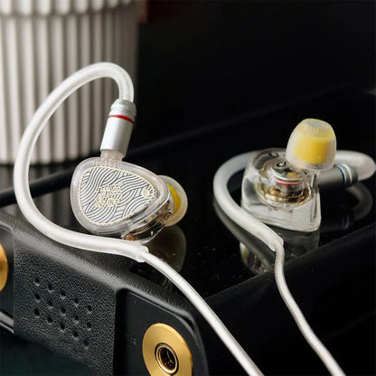 TANGZU Wan'er SG 2 IEMs with silver braided cable resting on audio player, showcasing premium build and stylish design.