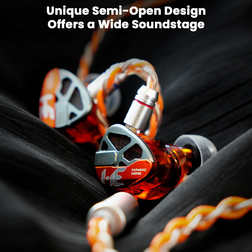 Close-up of high-end audio earbuds with orange and silver design on a dark background.