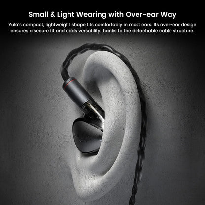 HiBy Yula IEM worn over-ear, demonstrating secure and lightweight fit ideal for extended listening sessions with detachable cable design.