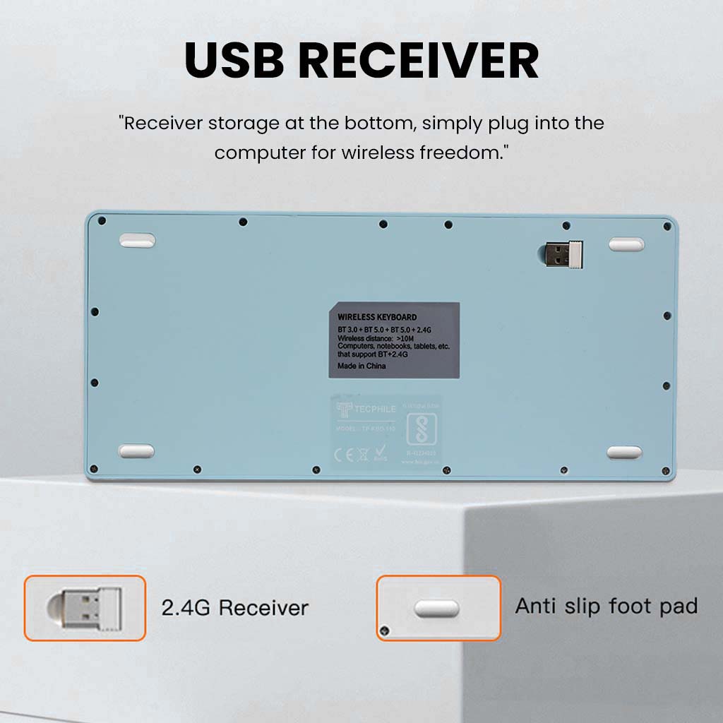 Bottom view of KB2858 Blue Wireless Keyboard showing USB receiver storage and anti-slip pads for secure desktop use.