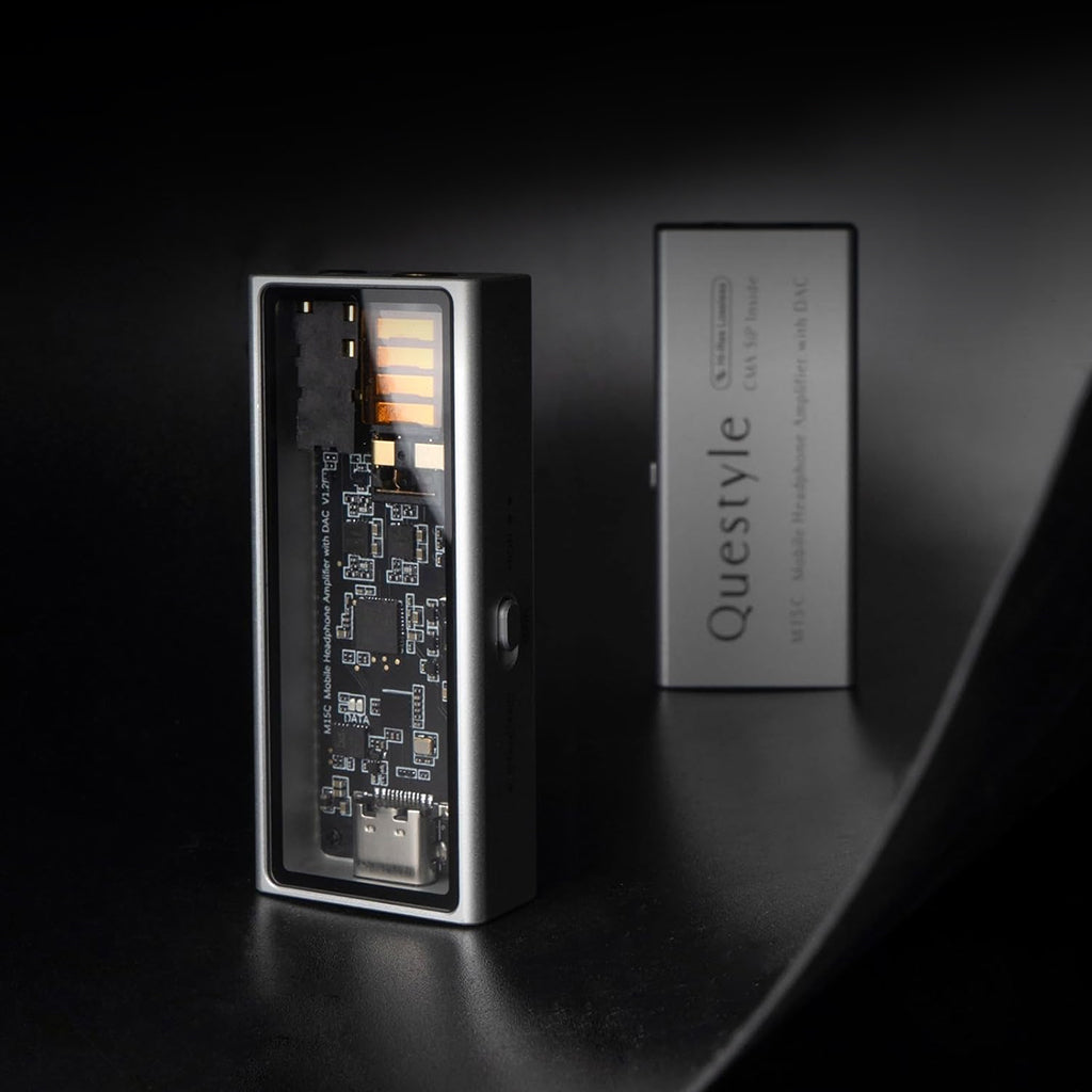 QUESTYLE M15C portable DAC/Amp displayed in a dark setting, highlighting its transparent panel and premium CNC-machined aluminum finish.