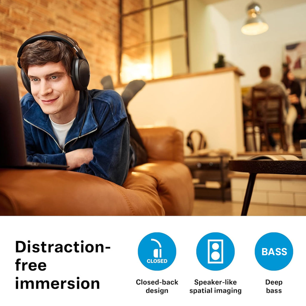 Man wearing Sennheiser HD 620S headphones while watching a laptop, highlighting closed-back design, deep bass, and spatial imaging features.