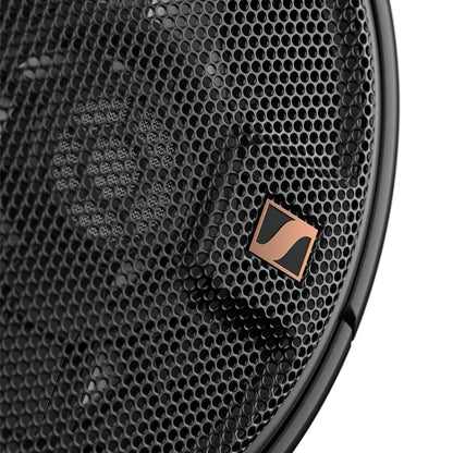 Close-up of Sennheiser HD 660S2 headphone earcup with bronze logo and precision-engineered mesh for open-back acoustic performance.