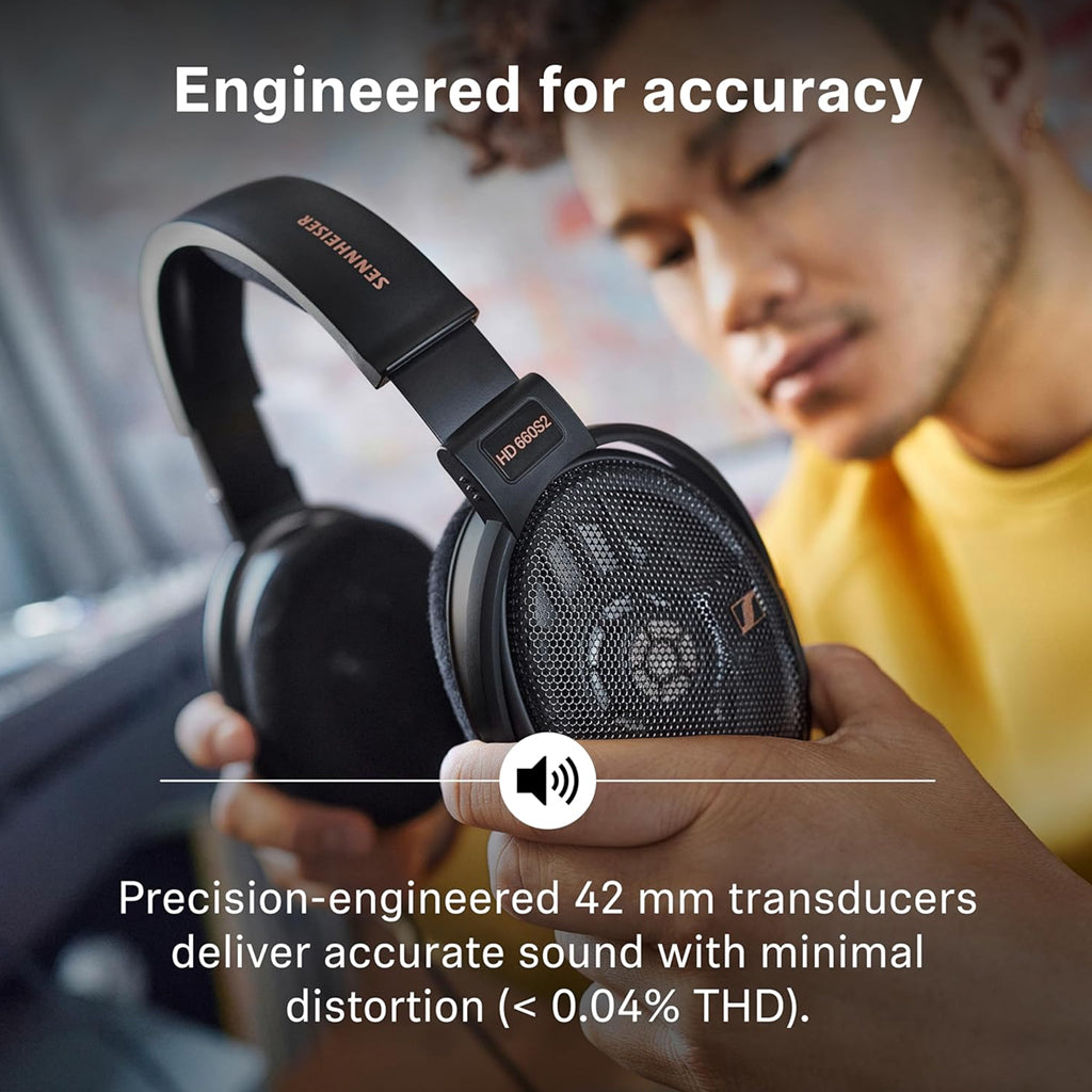 User holding HD 660S2 headphones with 42mm transducers, engineered for accurate sound reproduction and minimal distortion.