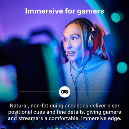 Gamer wearing HD 660S2 headphones in a vibrant setup, benefiting from immersive, non-fatiguing acoustics for precise positional audio.