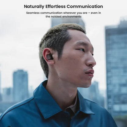 Man wearing Sennheiser Momentum True Wireless 4 earbuds in urban setting, emphasizing clear communication in noisy environments.