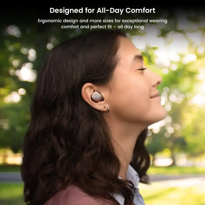 Woman enjoying outdoor comfort with Sennheiser Momentum True Wireless 4 earbuds, designed for ergonomic all-day wear and secure fit.