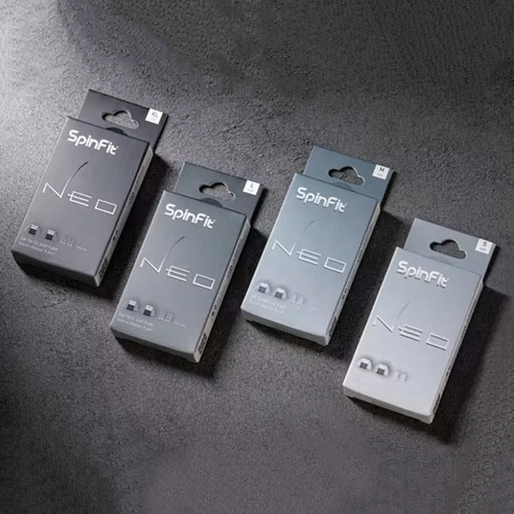SpinFit Neo Eartips retail packaging in various sizes displayed on dark surface, ideal for IEM users seeking comfort.