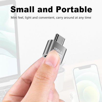 Compact and portable TECPHILE USB Type-C to USB A Adapter held between fingers, ideal for travel and daily use with laptops and phones.