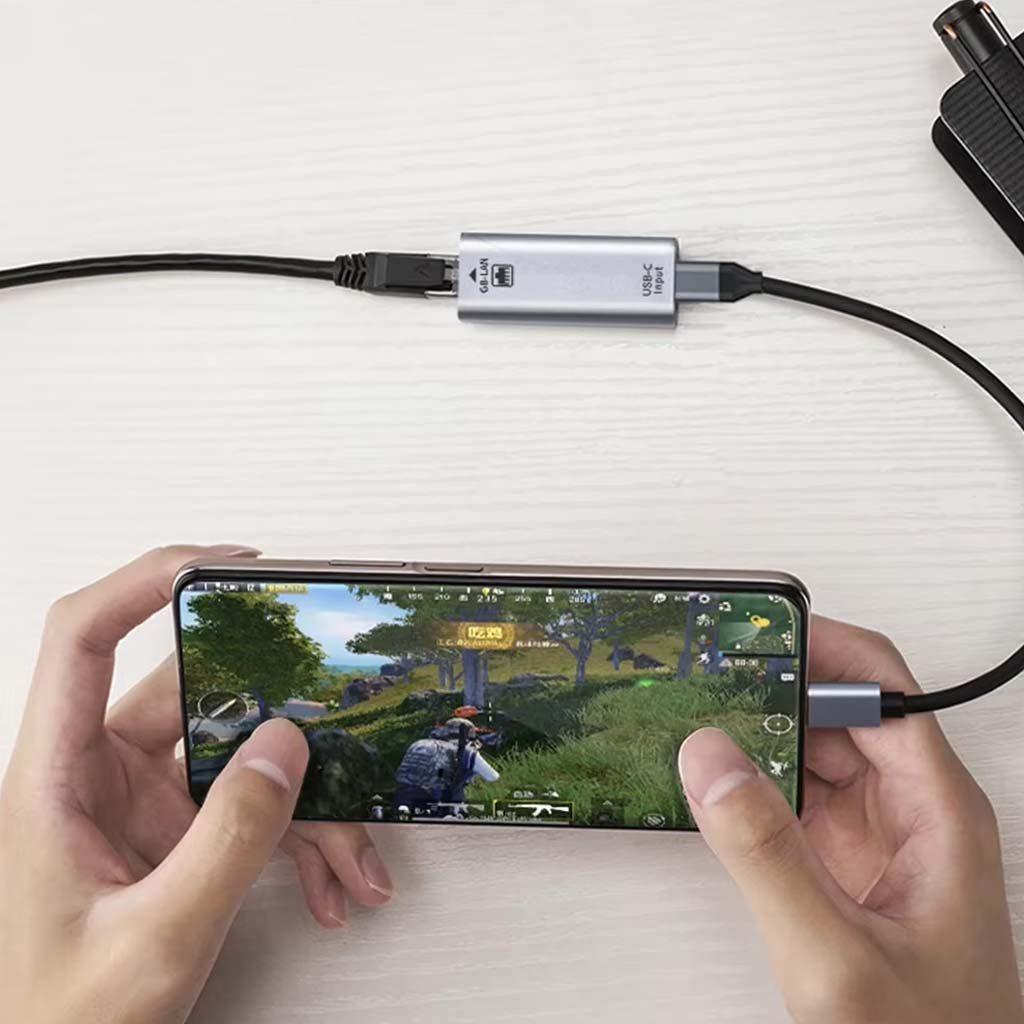 TECPHILE Type-C Ethernet Adapter used with a smartphone for low-latency gaming and stable network performance.