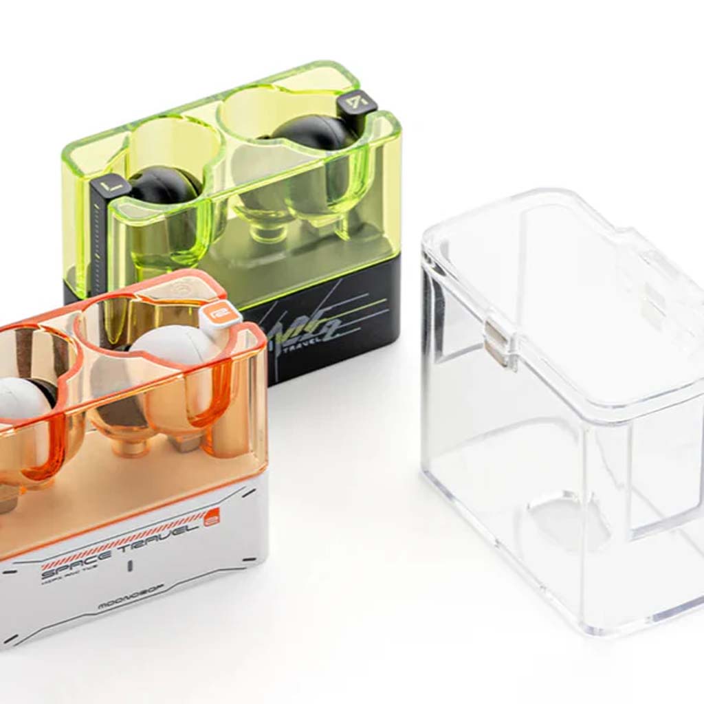 Moondrop Space Travel 2 cases in orange and green with earphones, plus empty clear case. Magnetic design for stylish audio gear storage.