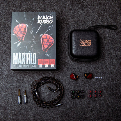 Complete Punch Audio Martilo 1 IEM package with ear tips, braided cable, adapters, carrying case, and retail box on dark textured surface.