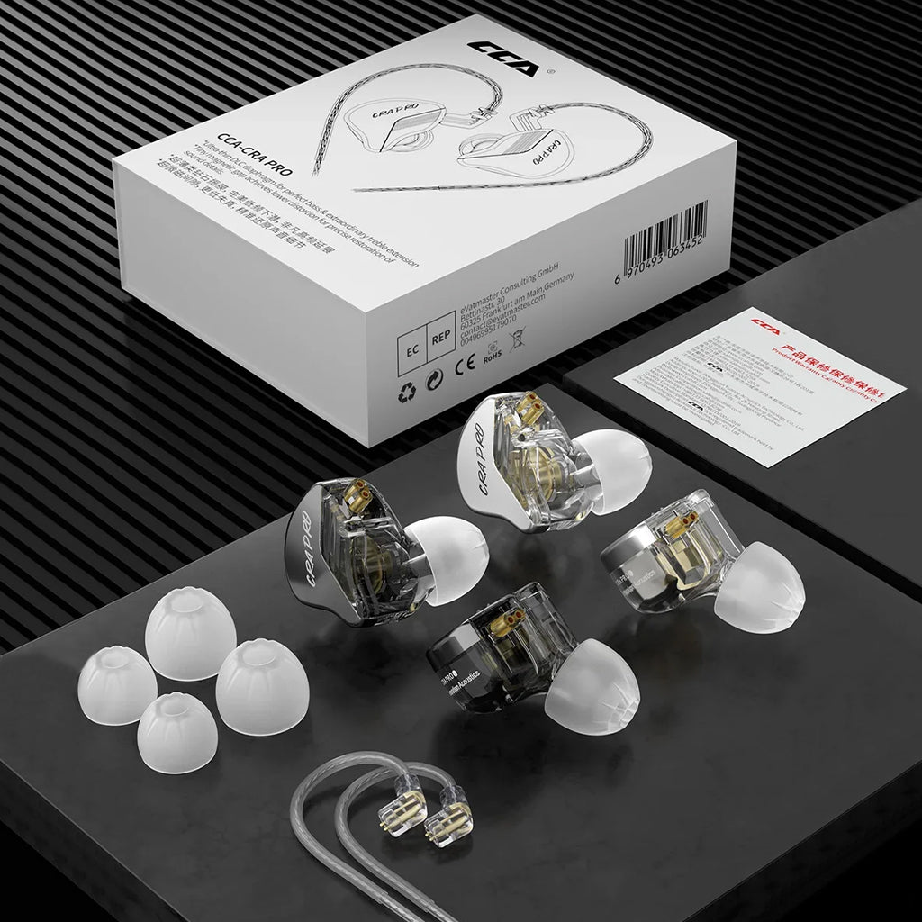 Unboxed CCA-CRA Pro IEM package with earbuds, silver-plated cable, ear tips, and user manual displayed on a black surface.