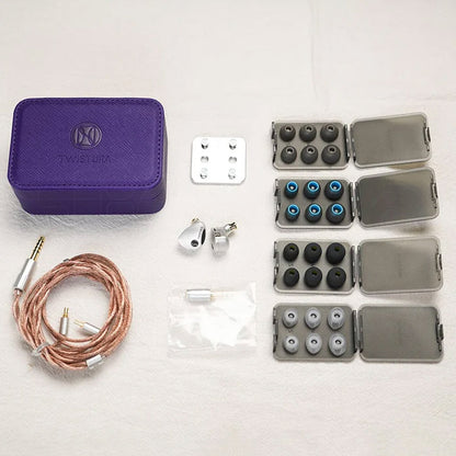 Complete TWISTURA Woodnote IEM package with ear tips, tuning filters, cable, and case, offering full customization and portability.