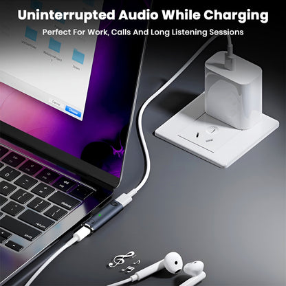 AUDIOCULAR A14X adapter connected to a laptop, enabling uninterrupted audio playback and charging simultaneously.