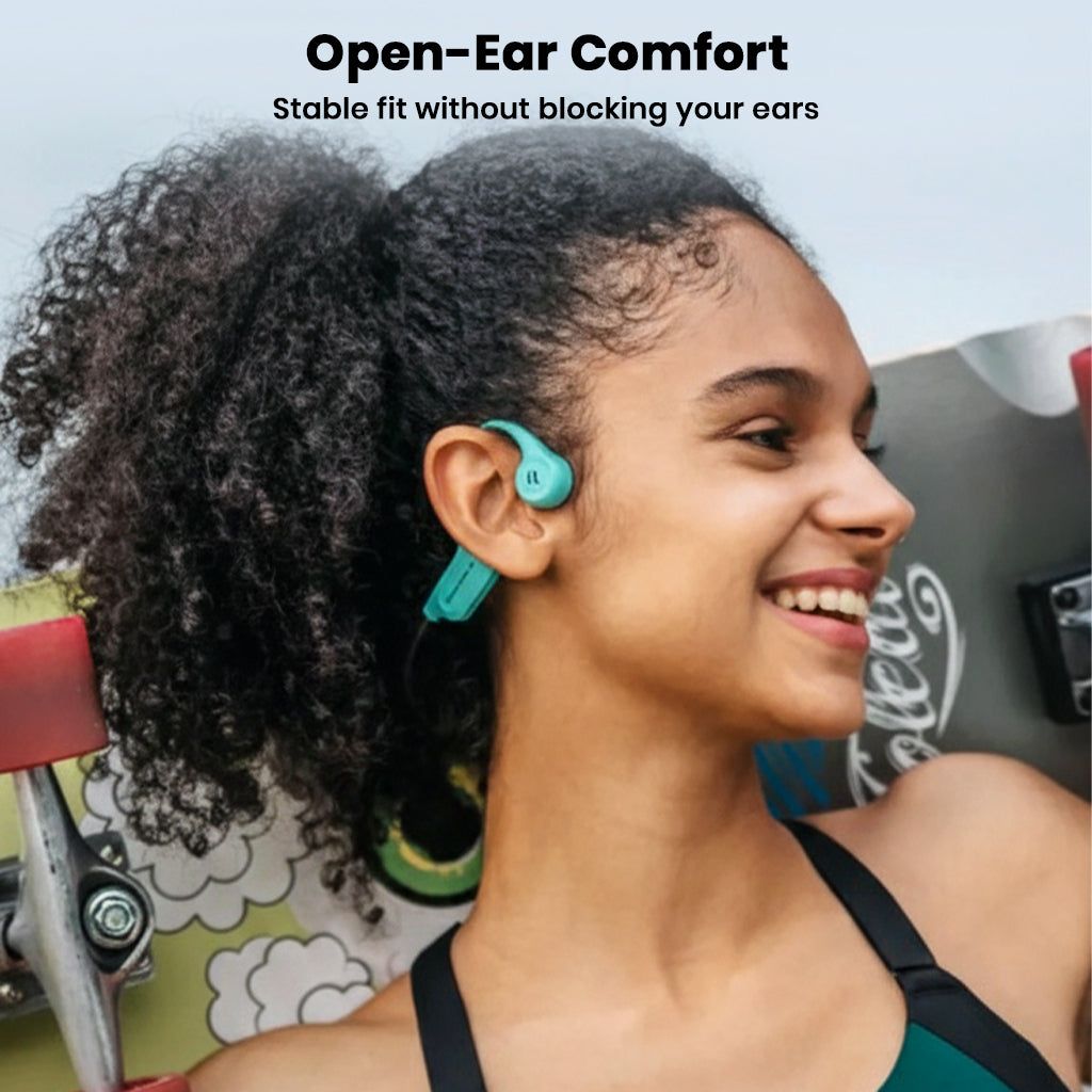 Woman wearing teal SHEYIN X5 headphones, demonstrating open-ear comfort and secure fit for active lifestyles.