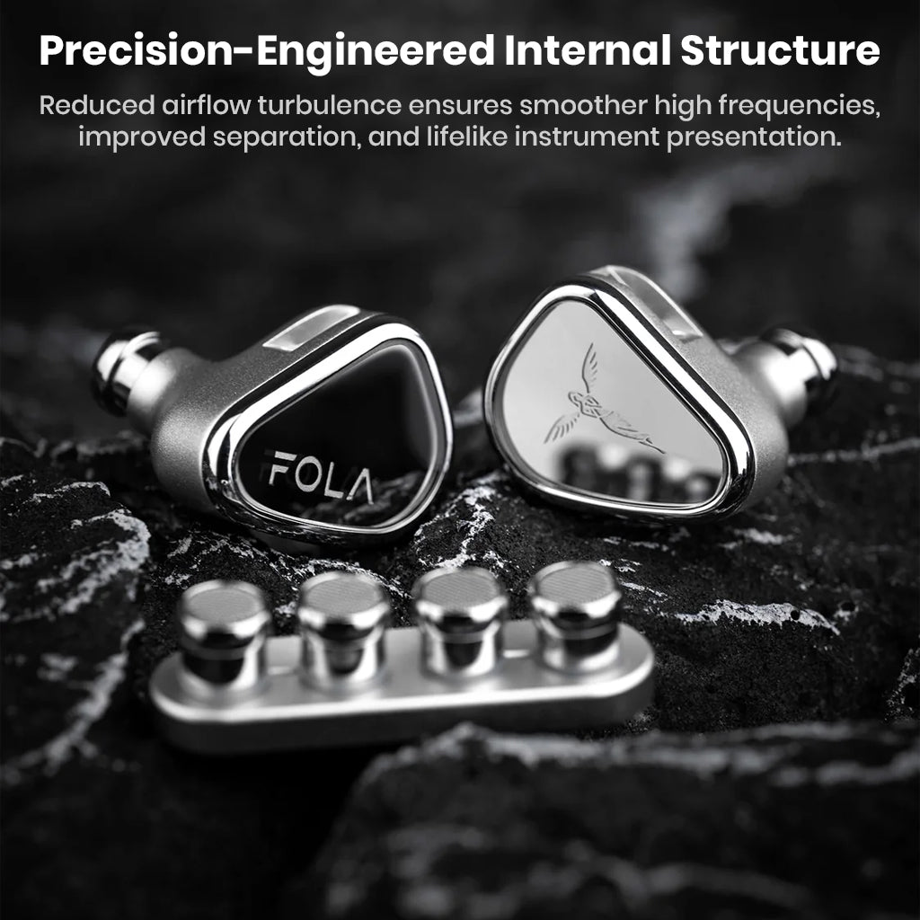 TANCHJIM FOLA IEMs on textured surface highlighting precision-engineered internal structure for lifelike sound separation and clarity.