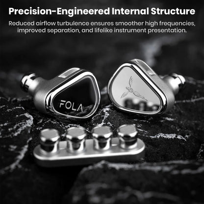 TANCHJIM FOLA IEMs on textured surface highlighting precision-engineered internal structure for lifelike sound separation and clarity.