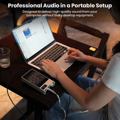 Questyle SIGMA Pro DAC/Amp connected to laptop, offering professional-grade audio in a portable setup without bulky equipment.