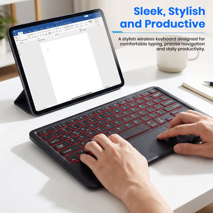 black wireless Bluetooth keyboard, slim profile, and ergonomic layout, used on a white desk with a laptop.